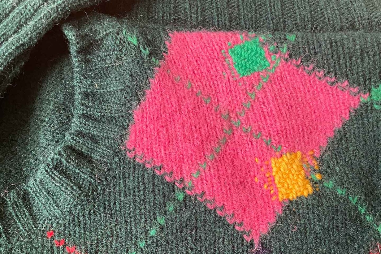 Sweater with parts mended using visual mending
