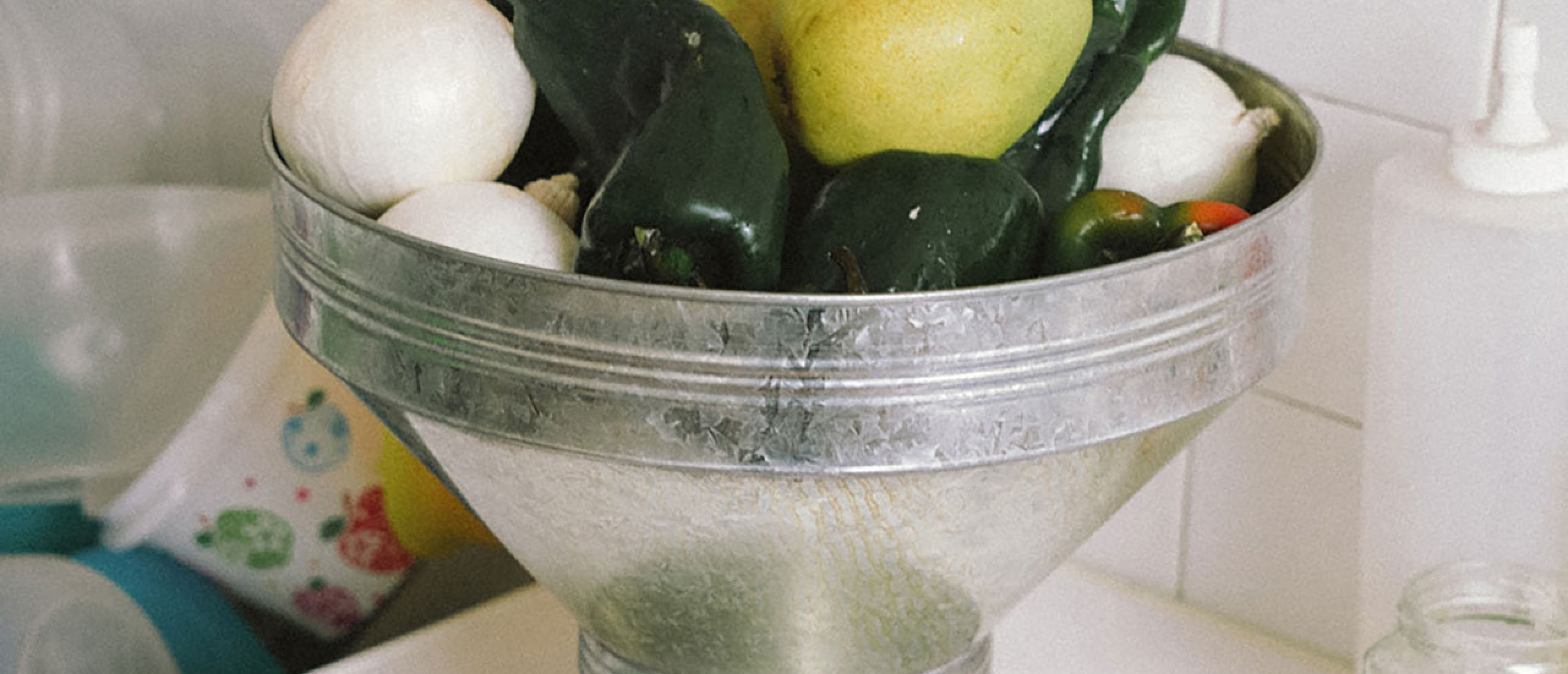 A vase or bowl with vegetables or fruit